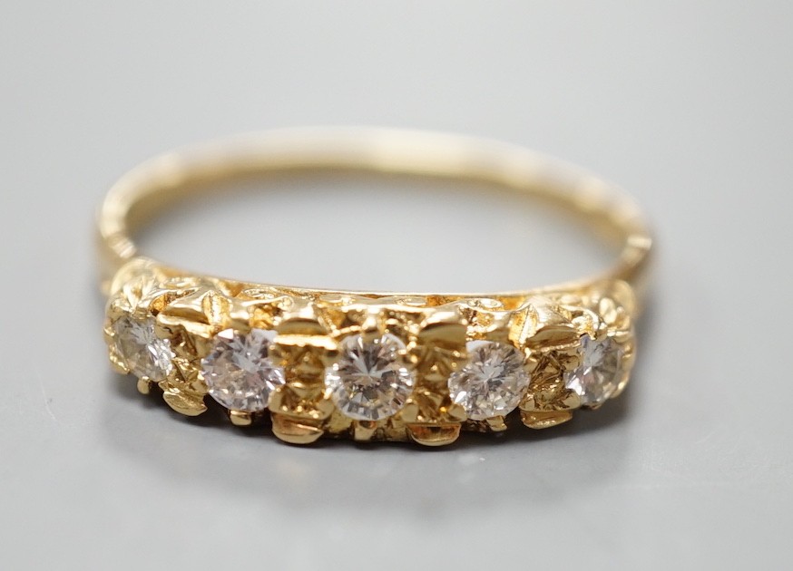 A modern 18ct gold and graduated five stone diamond set half hoop ring, size T, gross weight 3.8 grams.